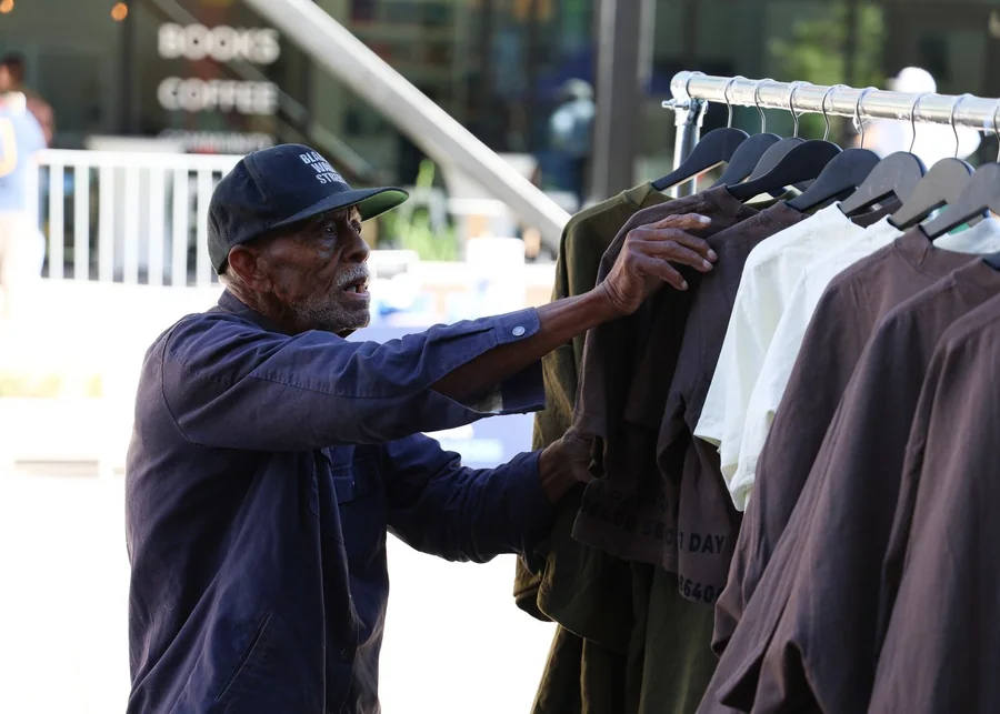 Block party vendor beside a clothing rack