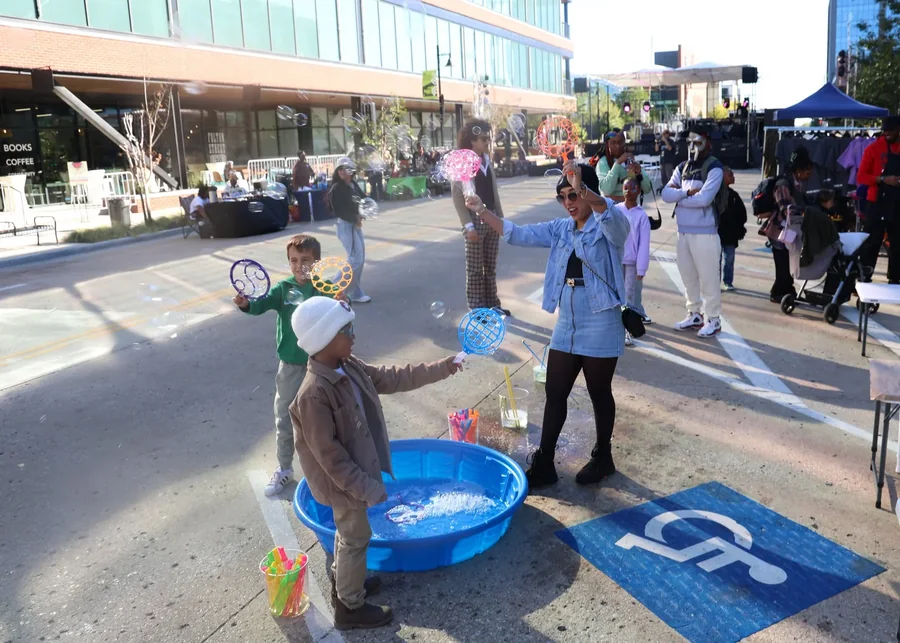 Children playing with bubbles at the block party